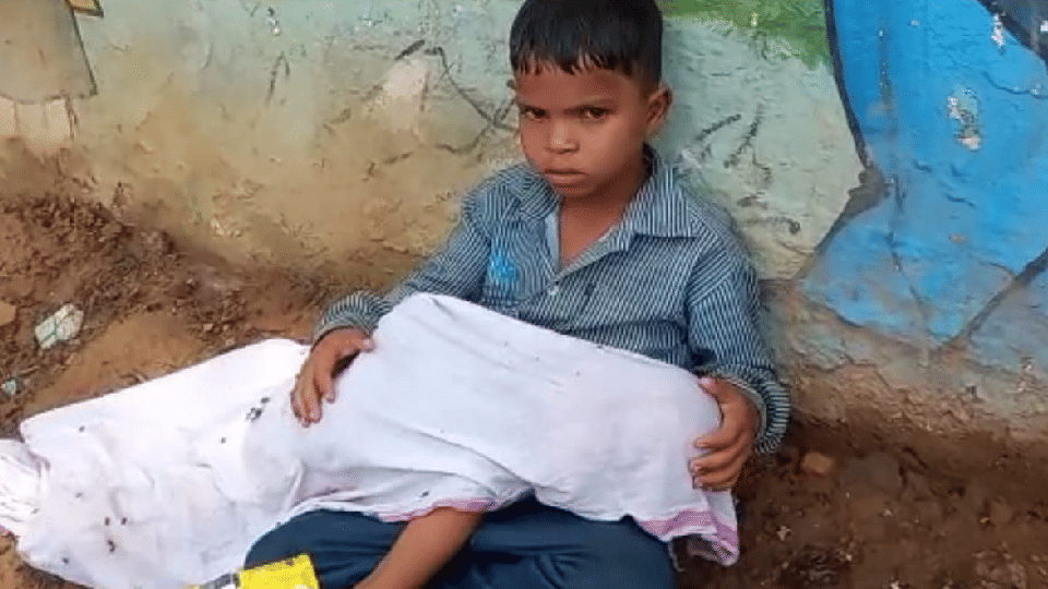 What kind of picture is this: Innocent sitting on the road with the body of a two-year-old brother in his lap, father wandering for a vehicle