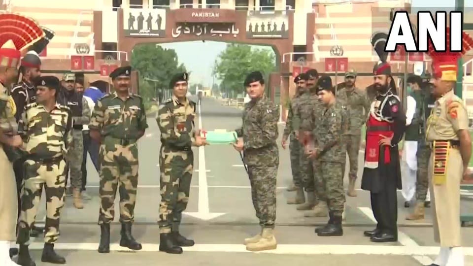 Border Security Force and Pakistan Rangers exchange sweets at Attari border on occasion of Eid Al Adha