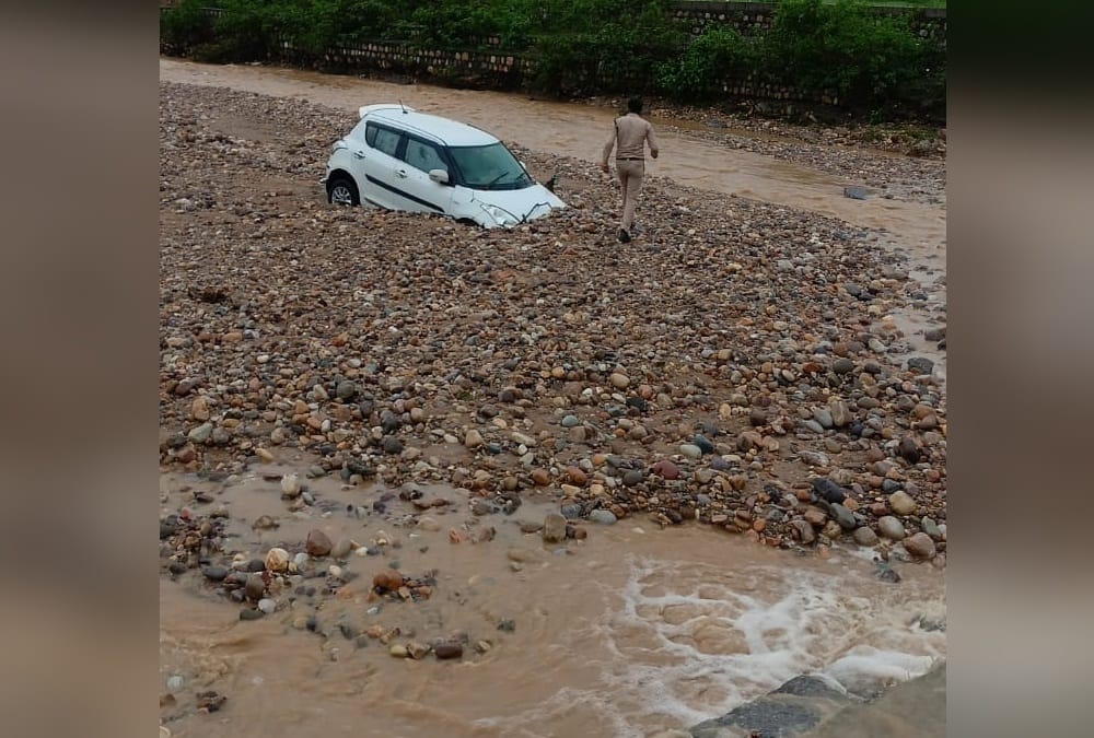Dehradun weather: Car swept during in heavy flow of flood and Youth died photos