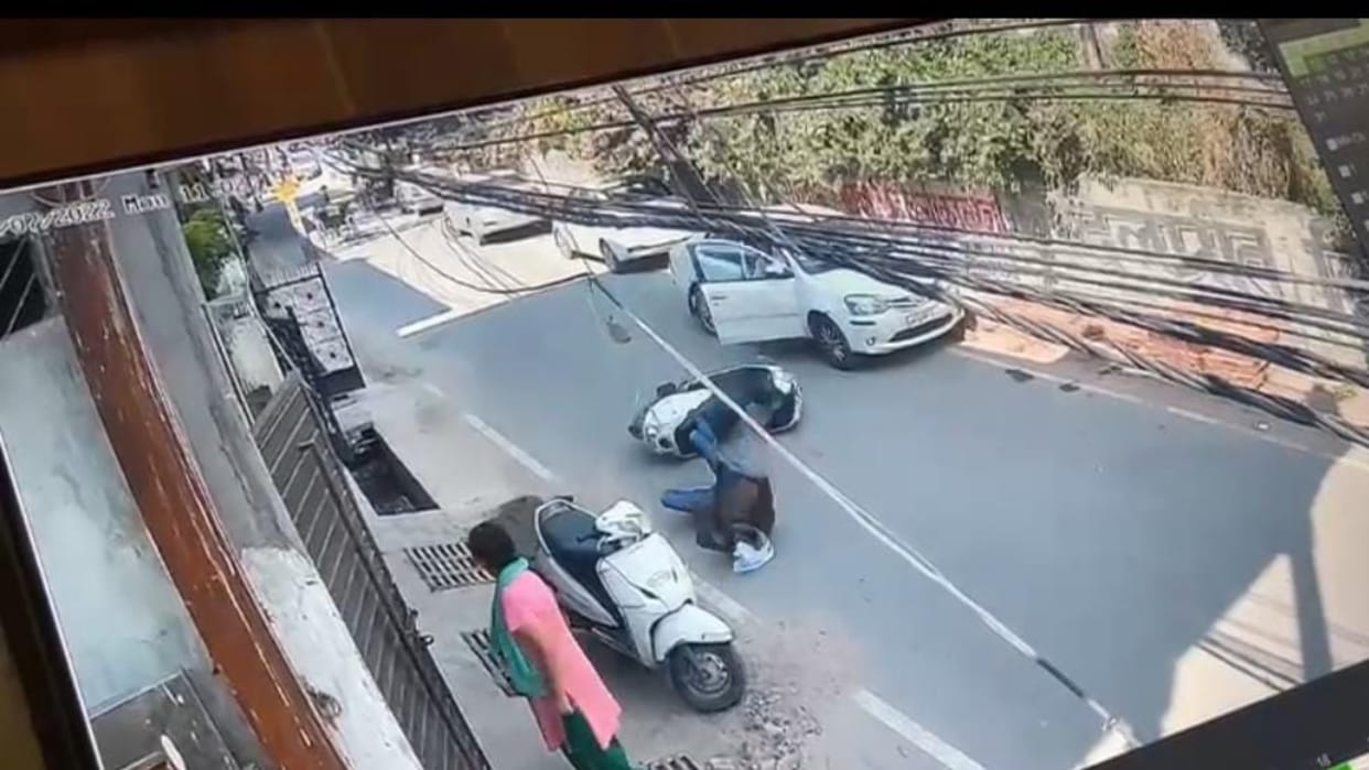 scooty driver died after collied in a car door in Lucknow.