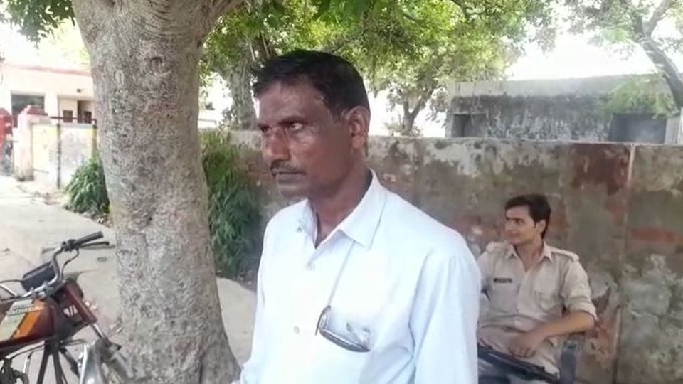man sells clothes by handcart under the police protection in etah