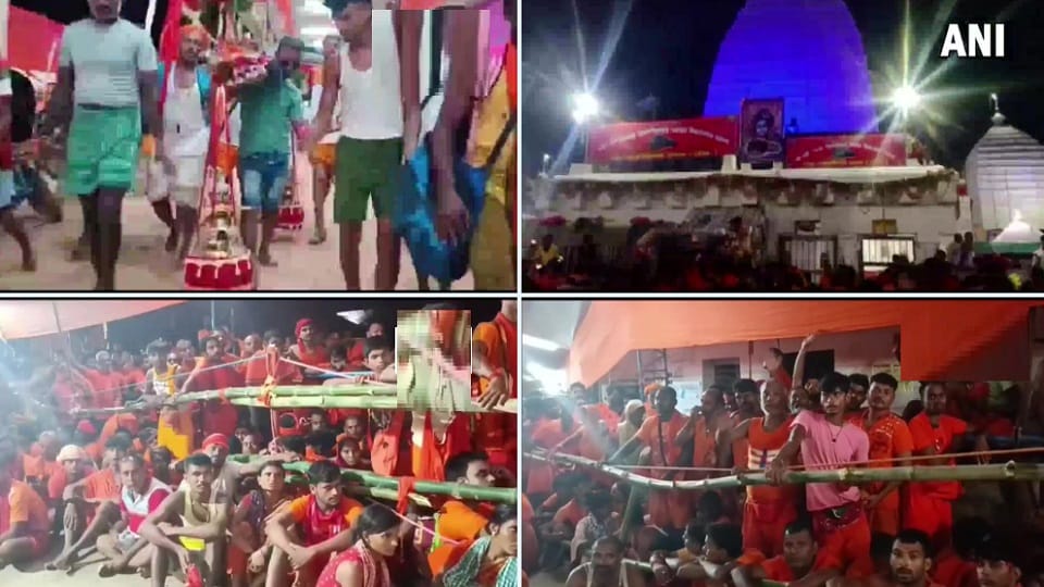 Kanwar devotees gather at a temple in Deoghar on the occasion of the first Monday of Sawan month