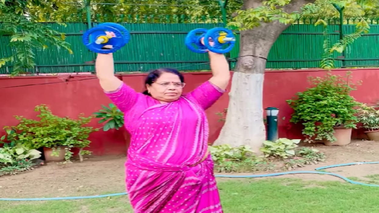 Rajya Sabha member Kanta Kardam exercising in saree by lifting dumbbells
