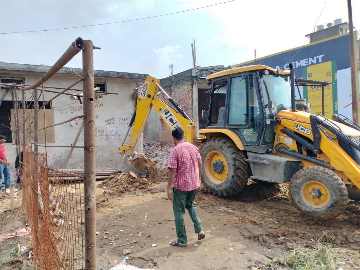 Bulldozer run on the building built on the land of the drain