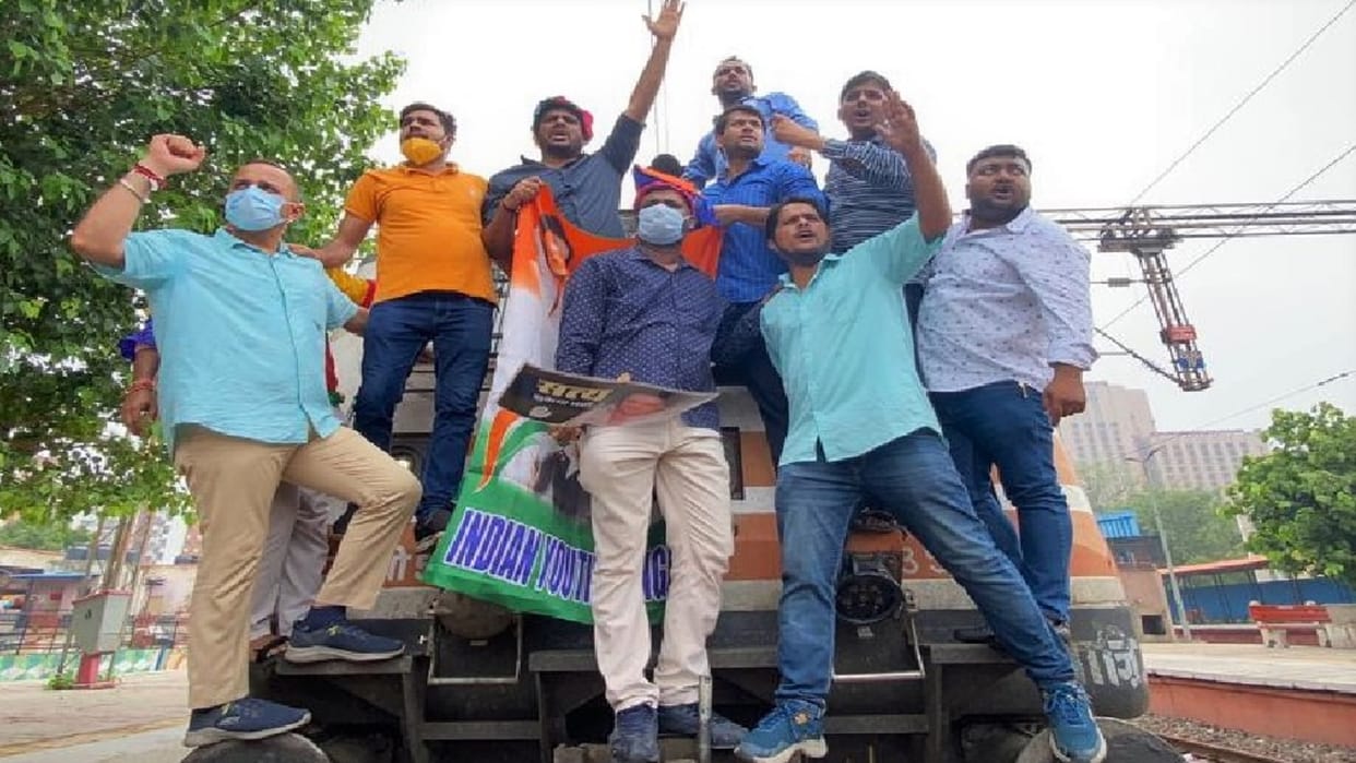 Congress workers demonstrated by climbing on engine of train