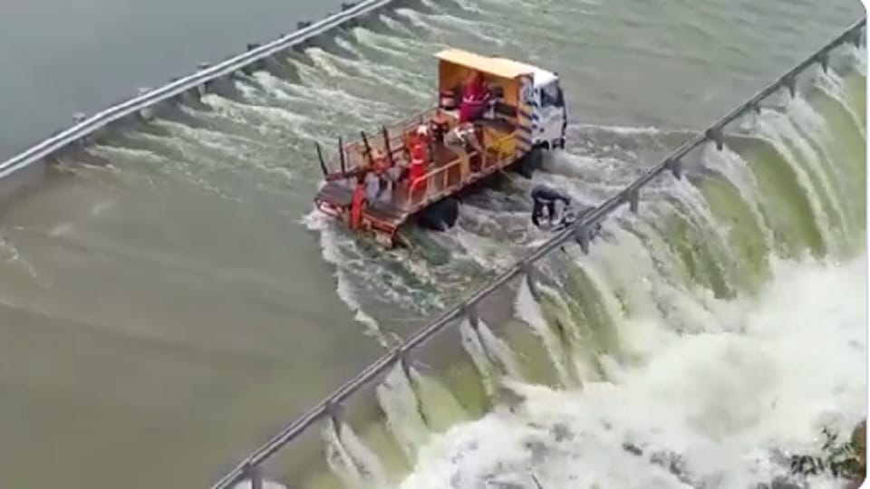 Telangana: civilian rescued who was trying to cross the inundated Himayath Sagar service road bridge on his bi