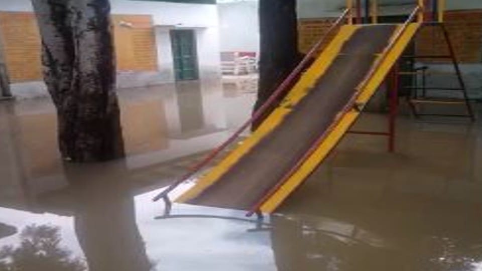 Water logging in primary school lady teacher reached with feet on chairs in mathura