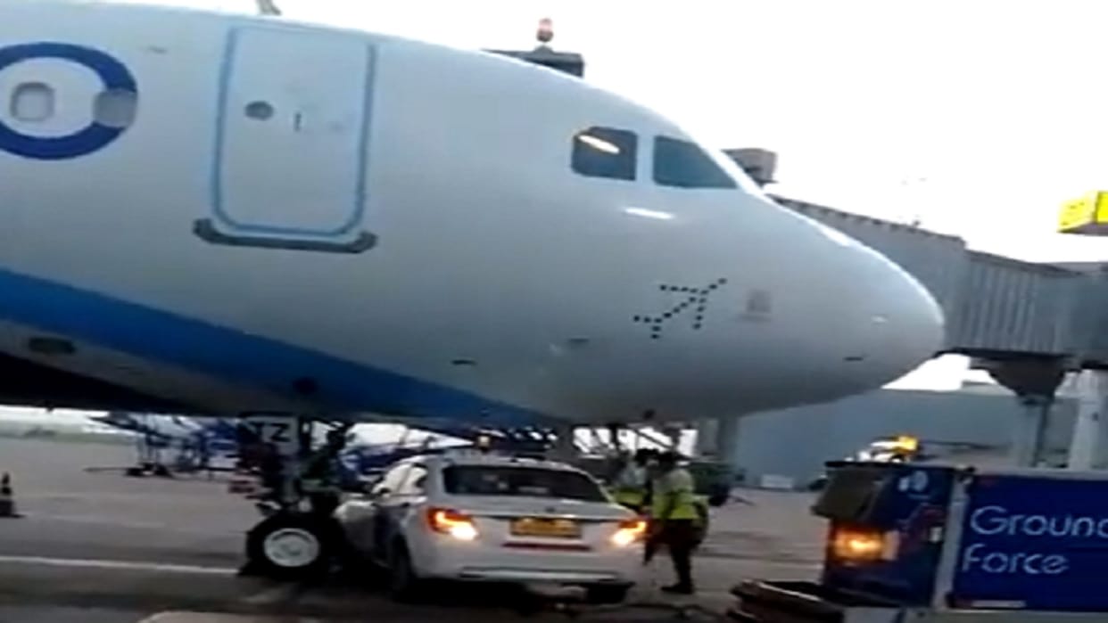 IGI airport, A Go Ground Maruti vehicle stopped under the nose area of the Indigo aircraft