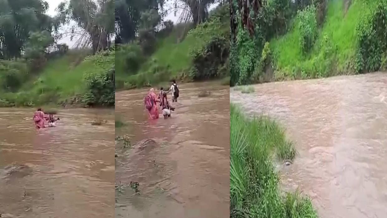 Students of Bhairada reaching school after crossing flooded khadd risking their lives