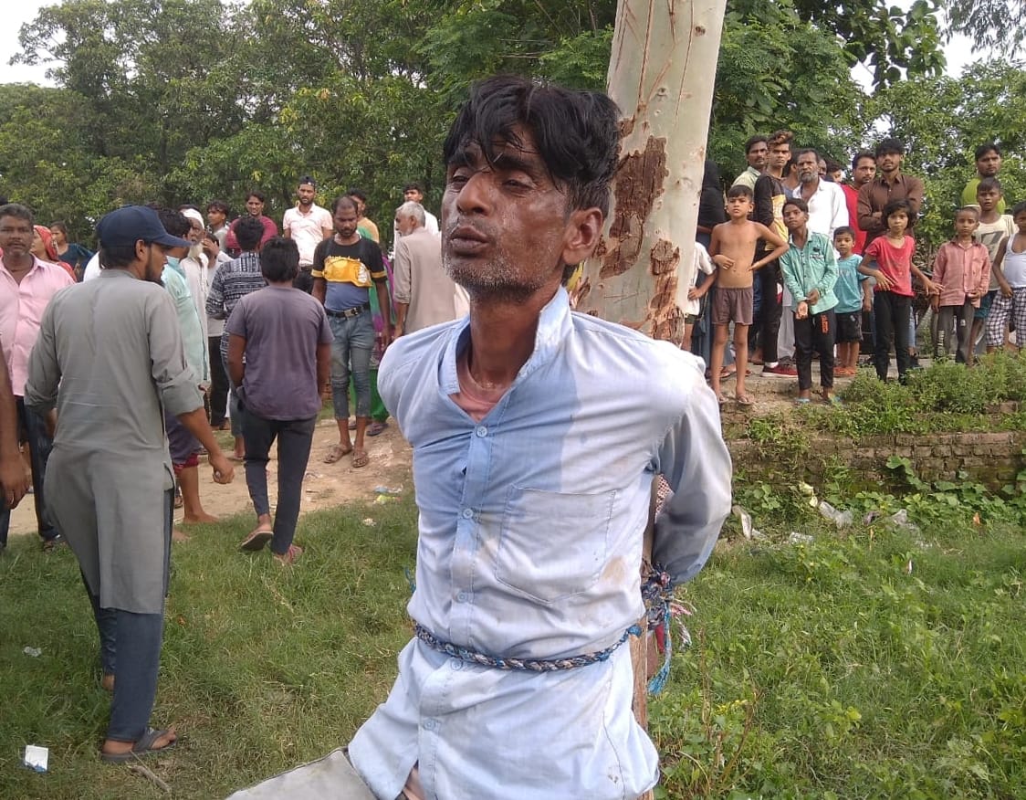 The accused, who injured two people by firing, was tied to a tree