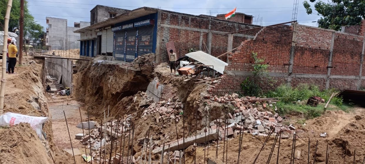 Due to random excavation of big drain houses started cracking wall of two fell