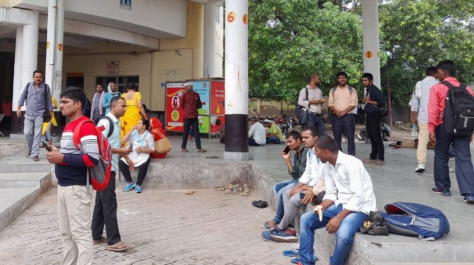 Passengers helpless in roadways depot, waiting for buses while sitting on the floor