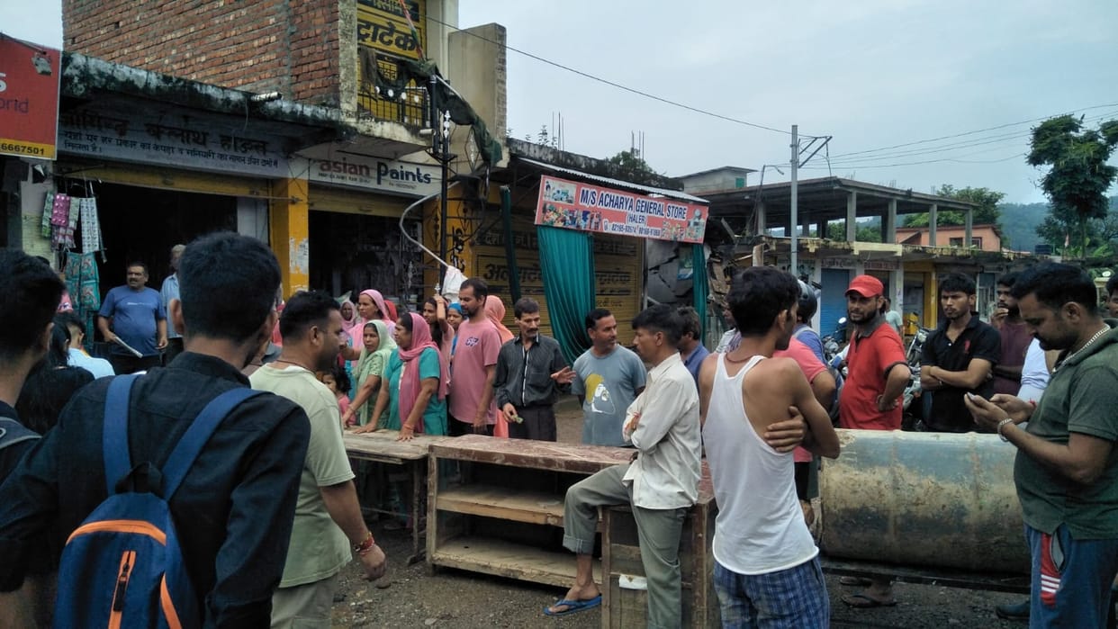 Angry people blocked the road due to water entering shops and houses