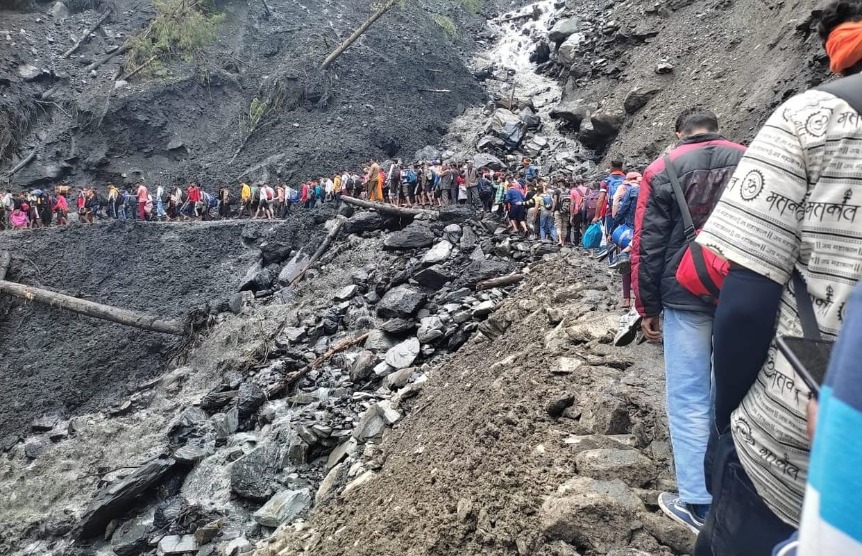 Devotees crossing Pranghala drain with the help of trees