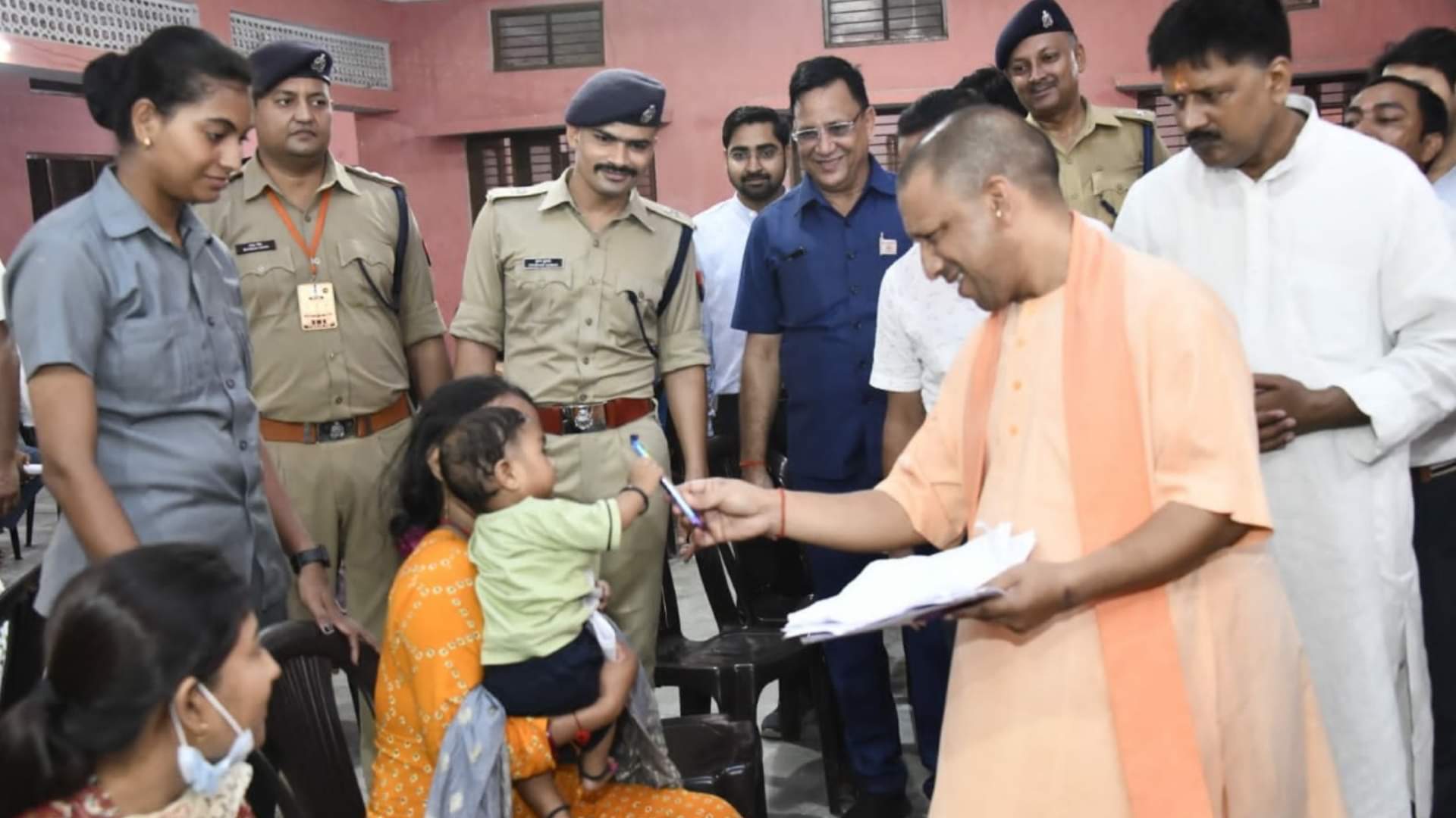 जनता दरबार में बच्चे को चॉकलेट देते सीएम योगी।