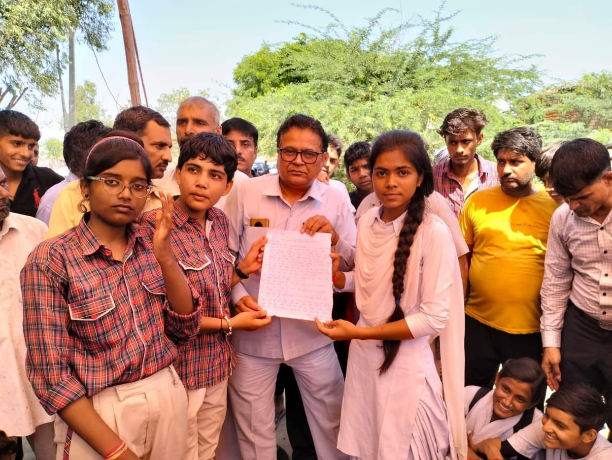 Girl students and parents put a lock on the school gate