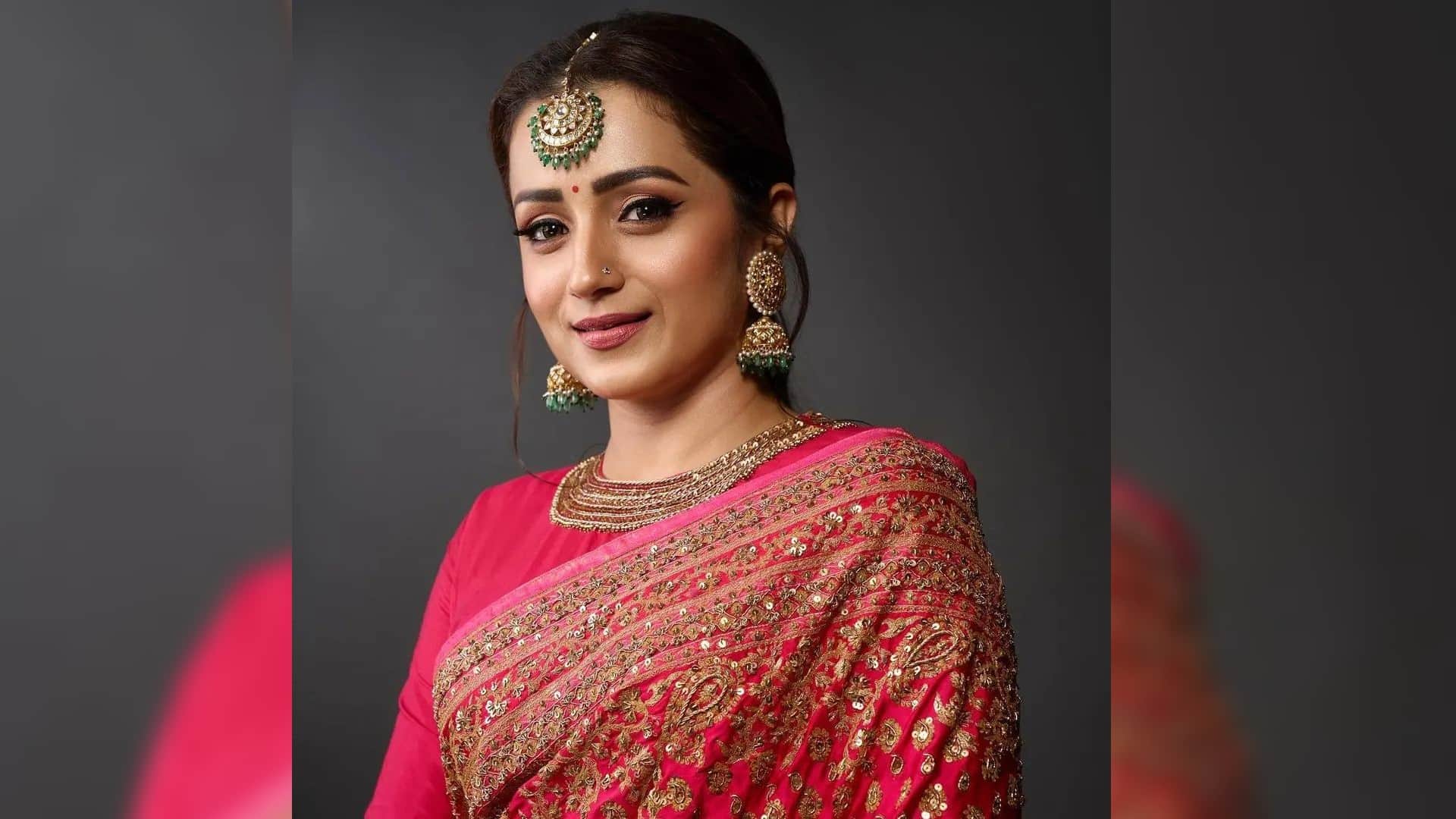 trisha krishnan in bright pink saree with heavy embroidery and maang tikka for movie ponniyin selvan trailer l