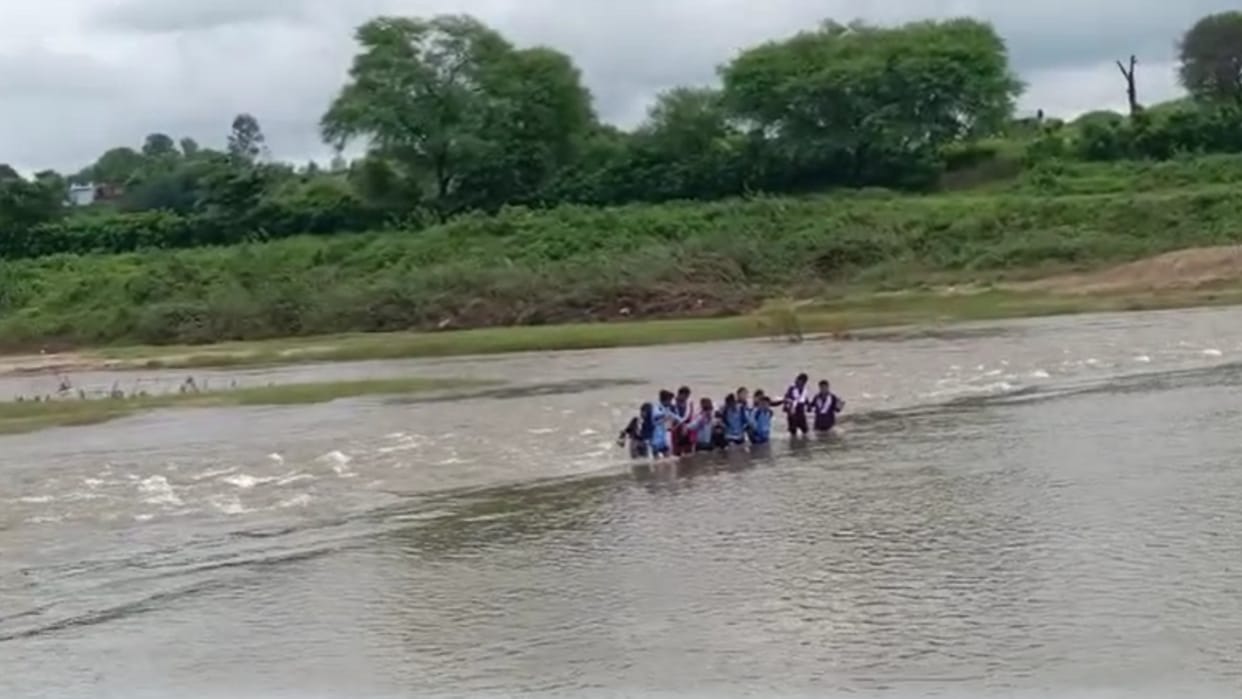 Students crossing the raging river risking their lives administration is not taking care