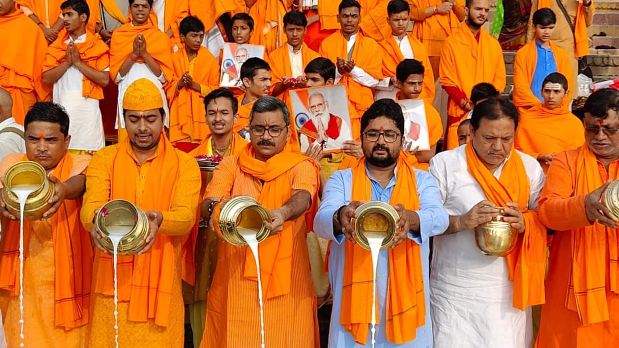 PM Modi birthday live updates Milk ceremony on PMs birthday celebrated by cutting cake at Namo Ghat