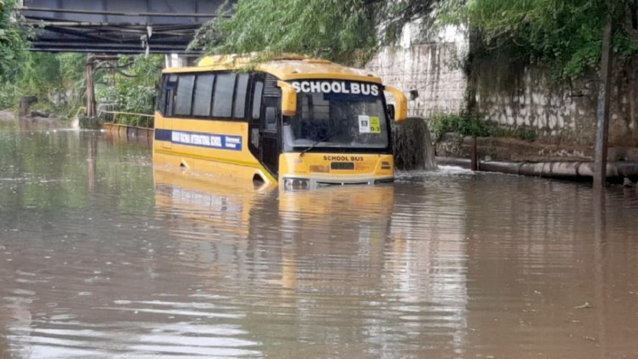 Students panic School bus stuck between water in underpass in Faridabad