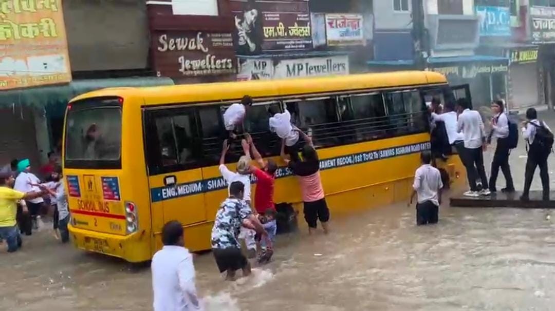 Smoke rises from school van on Dharamshala Road, children jump from windows