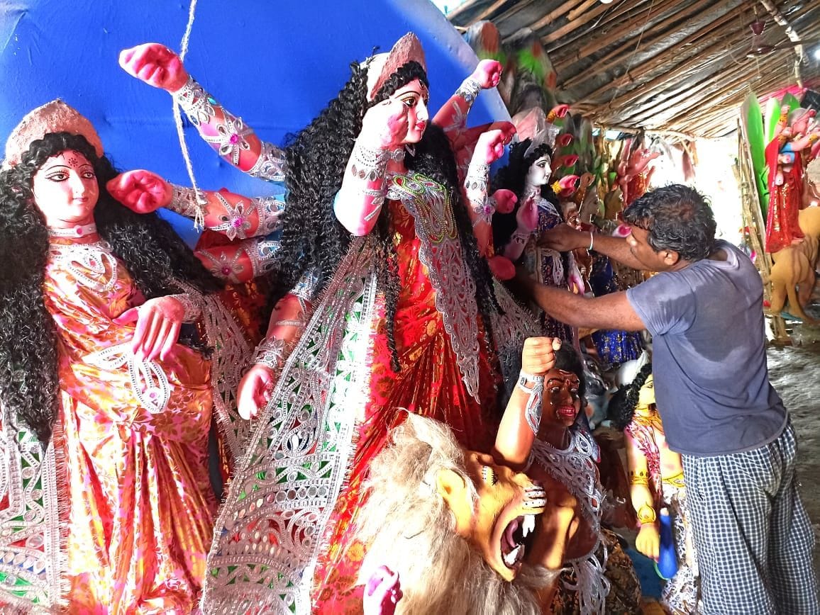 Artists engaged in finalizing the statues of the mother