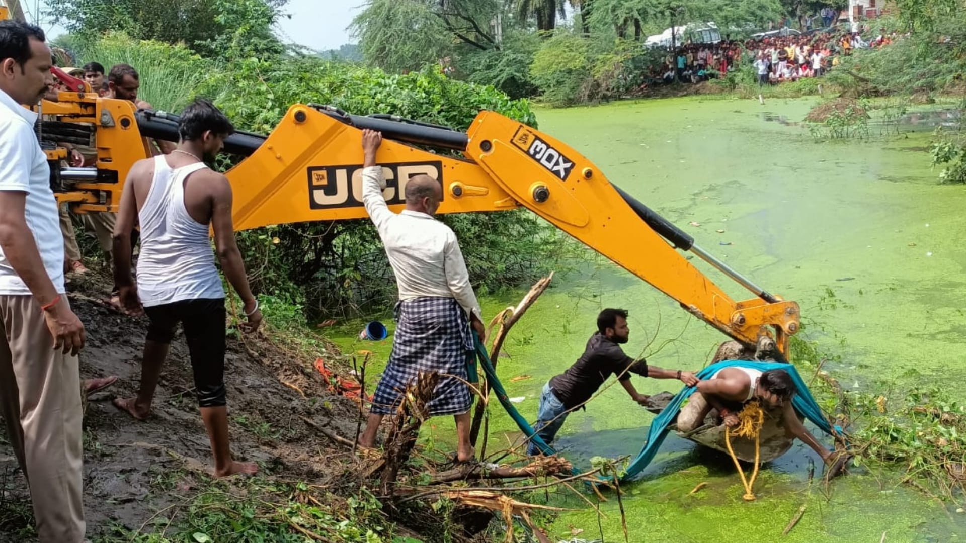 A tractor trolly falls in a pond in Itaunja in Lucknow.