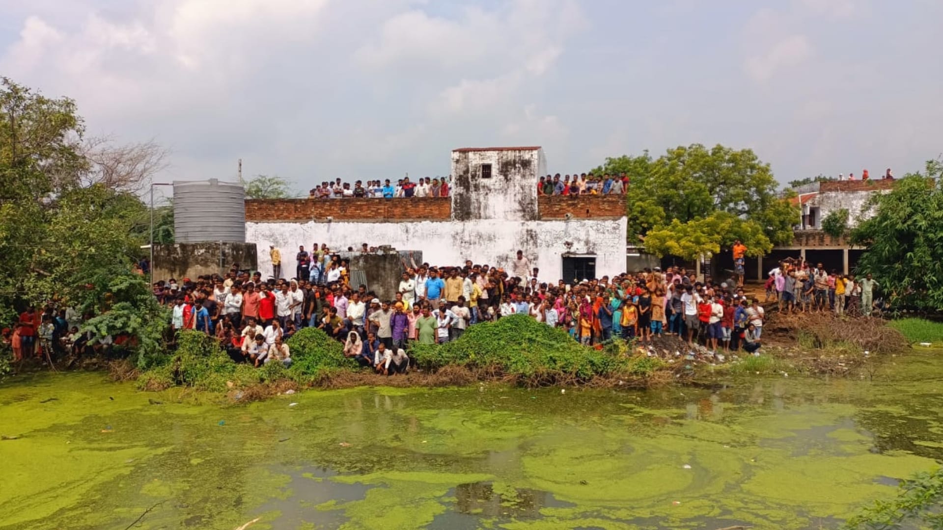 A tractor trolly falls in a pond in Itaunja in Lucknow.