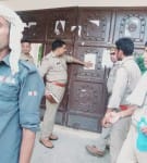 गांव अमृतपुर रघुपुर में नोटिस चस्पा करती पुलिस ।संवाद