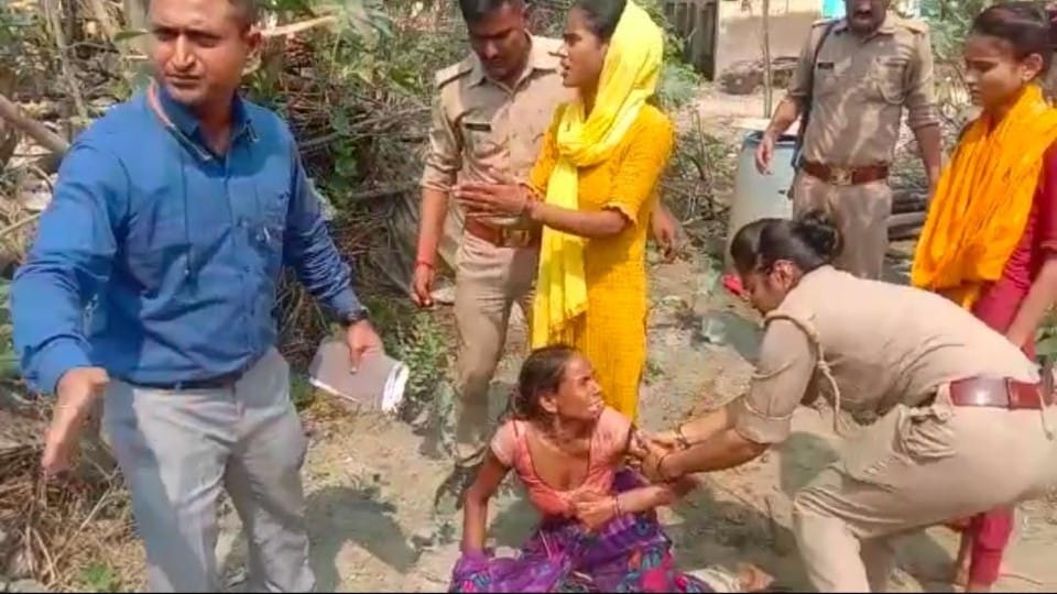 Women lying in front of bulldozer in agra revenue team went to remove possession from government land