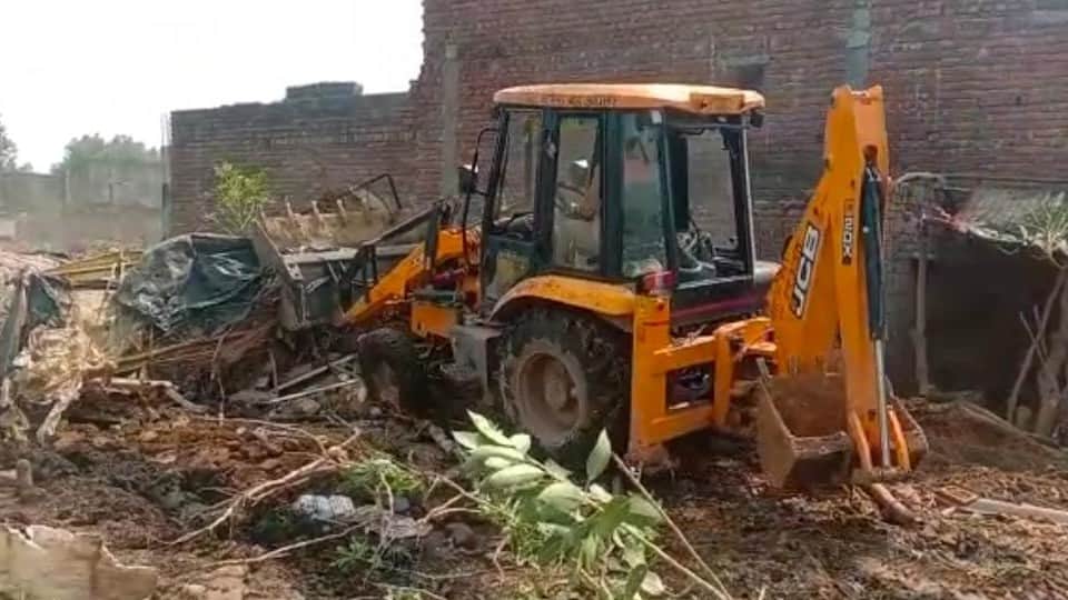 Women lying in front of bulldozer in agra revenue team went to remove possession from government land