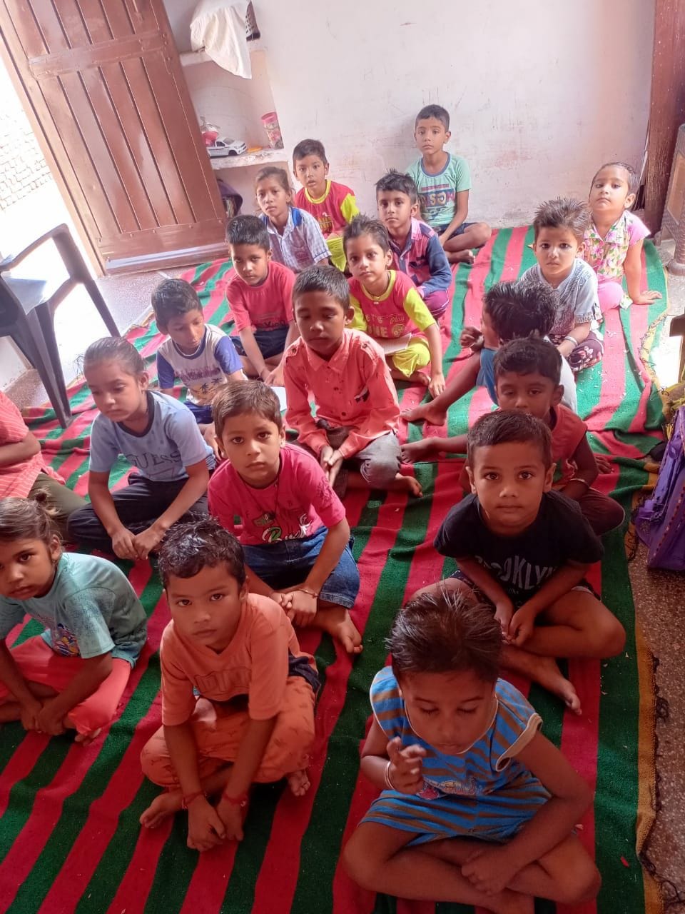 Harpreet writes the future of the children on the blackboard, teaching the children at her home