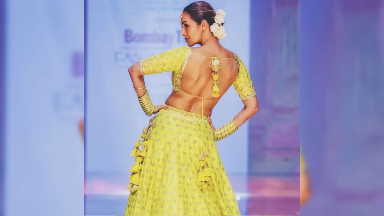 malaika arora walk on ramp in yellow lehenga with backless blouse totally traditional style