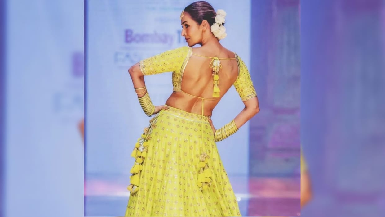malaika arora walk on ramp in yellow lehenga with backless blouse totally traditional style
