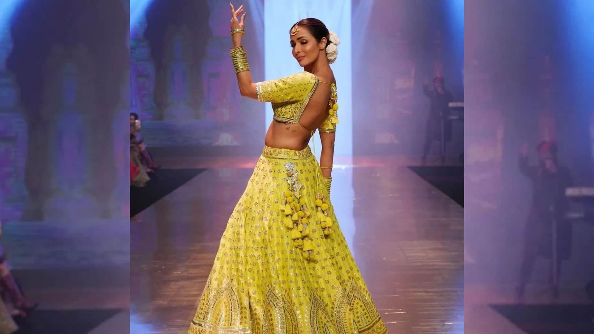 malaika arora walk on ramp in yellow lehenga with backless blouse totally traditional style