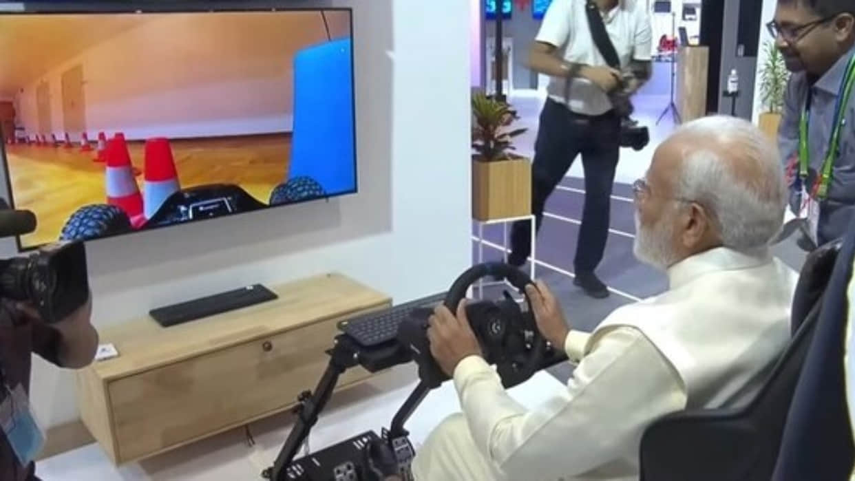 PM narendra Modi test driving a car in Europe from Delhi using 5G technology