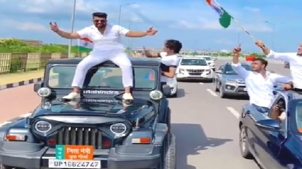 video of youth sitting on vehicle with name plate of BJP District Minister Yuva Morcha violating traffic rules
