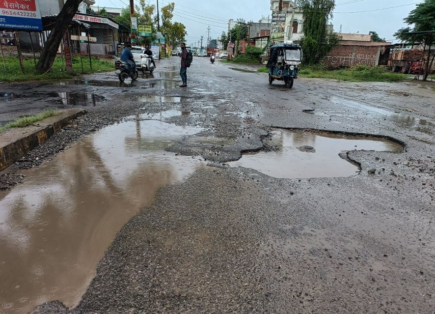 Potholes and waterlogging on roads, passers-by