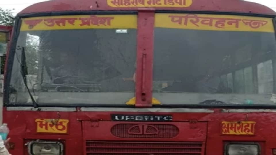Drivers of UP roadways buses handlin steering of bus with one hand wipers running with the other