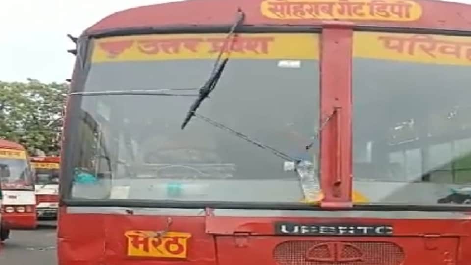 Drivers of UP roadways buses handlin steering of bus with one hand wipers running with the other