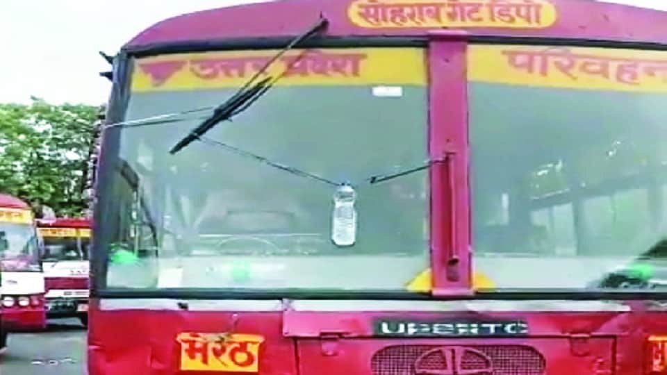Drivers of UP roadways buses handlin steering of bus with one hand wipers running with the other