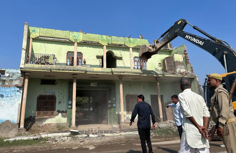 building demolished by bulldozer