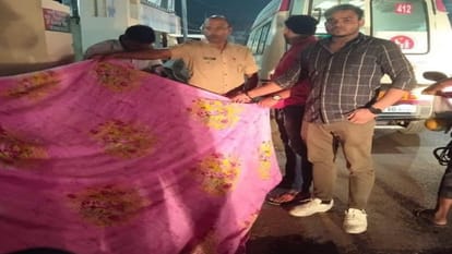 Policemen help to a woman suffering from labor pain on the road in varanasi