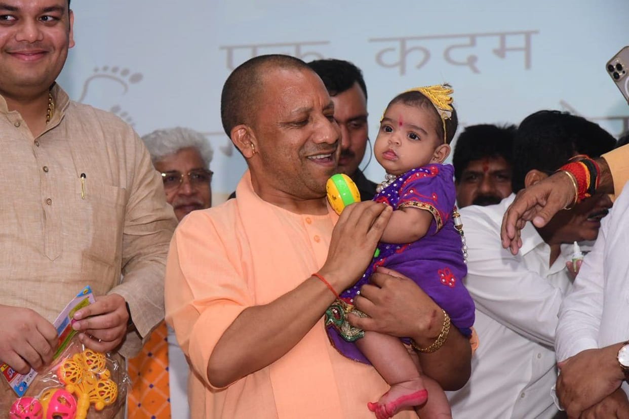 Hand-fed kheer to children, cherished by taking them in their arms