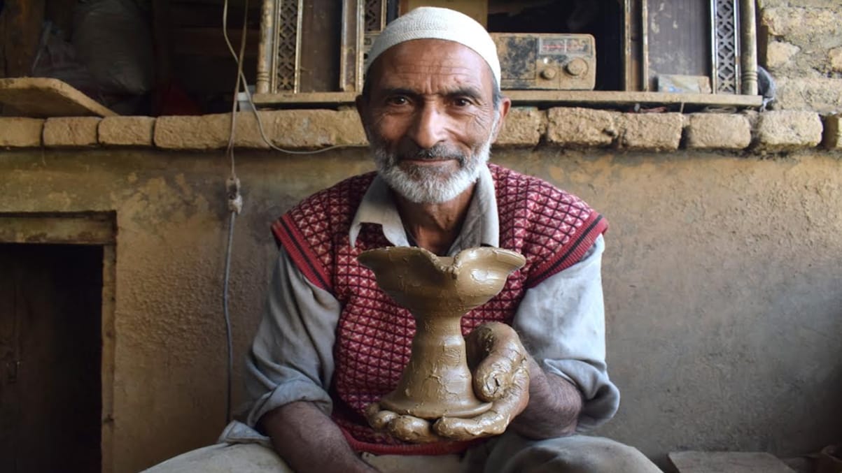 Kashmiri Muslim potter makes earthen lamps at his home workshop ahead of Diwali
