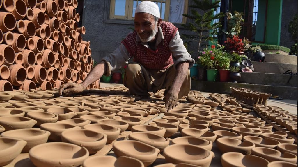 Kashmiri Muslim potter makes earthen lamps at his home workshop ahead of Diwali