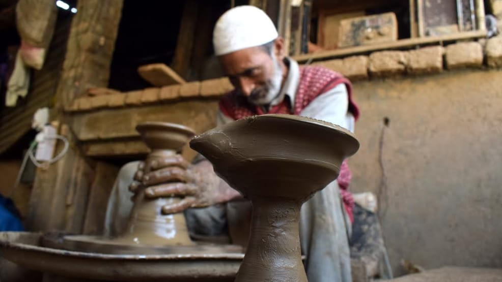 Kashmiri Muslim potter makes earthen lamps at his home workshop ahead of Diwali