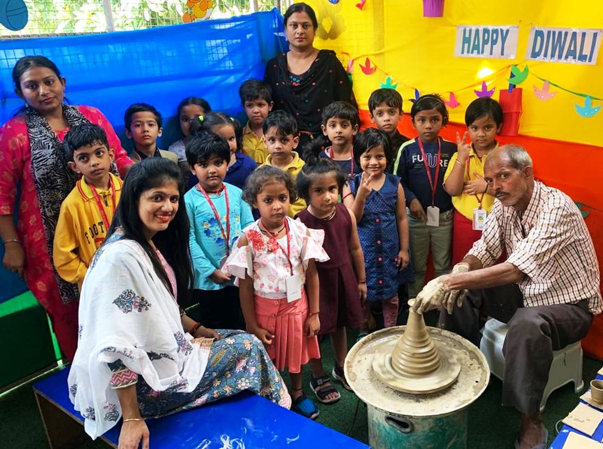 Children thrilled to see the potter's wheel moving