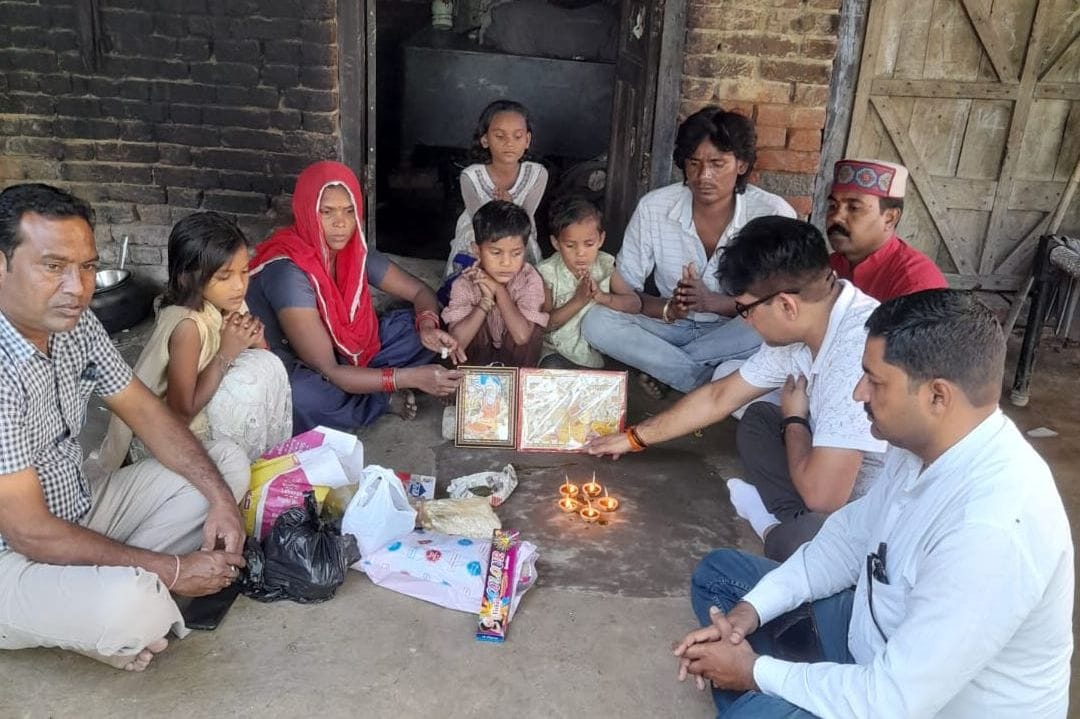 Distributed happiness by giving sweets and diyas to the poor