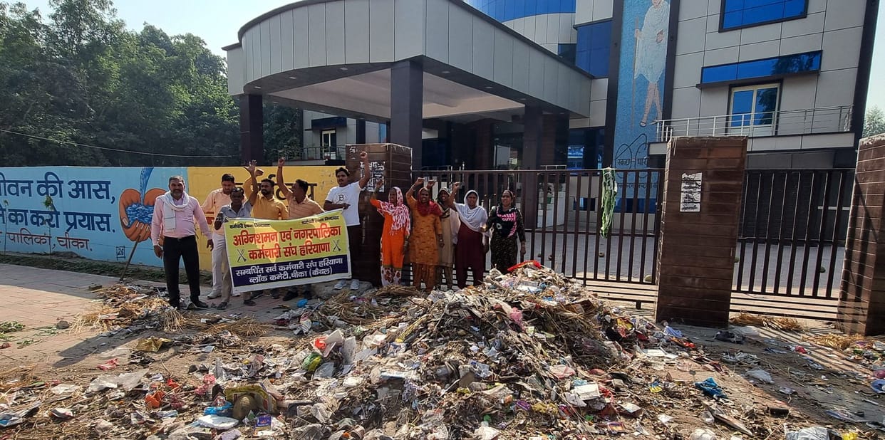 Sanitation workers demonstrated by throwing garbage in front of the main gate of NAPA office